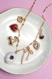 CHARM NECKLACE-PORCELAIN STRAWBERRY CHERRY BOW | 80N92144