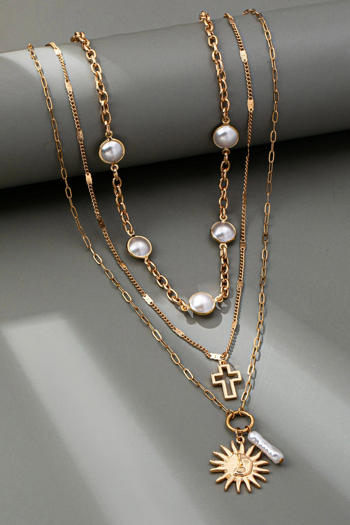 MULTI PEARL LAYER PEARL SUN CROSS CHARM NECKLACE | 80N92503