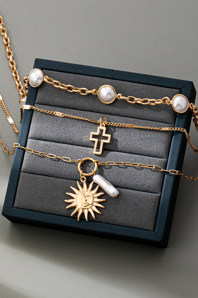 MULTI PEARL LAYER PEARL SUN CROSS CHARM NECKLACE | 80N92503