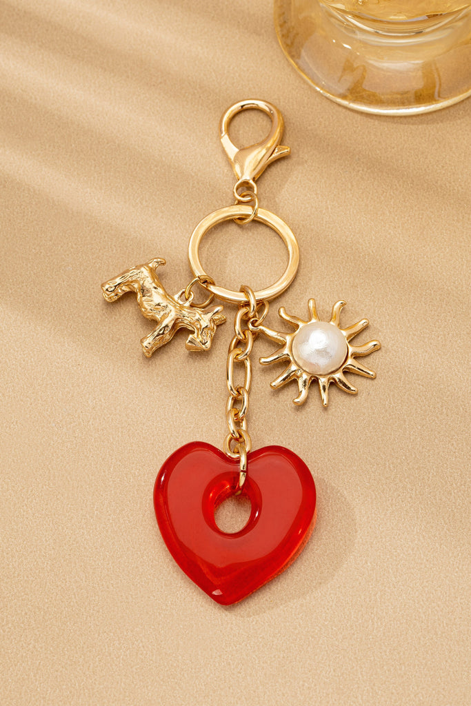 BAG CHARM KEY CHAIN-RESIN HEART DOG PEARL SUNBLAST | 80K092