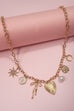 SUN BOW PEARL CROSS DISC U CHARM NECKLACE | 80N1182