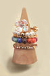 LAYERED MULTI BEADED FLORAL BOW STACKABLE RING SET | 80R053
