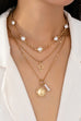 MULTI PEARL LAYER PEARL SUN CROSS CHARM NECKLACE | 80N92503