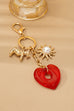 BAG CHARM KEY CHAIN-RESIN HEART DOG PEARL SUNBLAST | 80K092