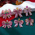 Pink Coquette Holiday Acrylic Bow Drop Earrings | 80E63507