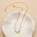 MINI GOLD BOW CHARM NECKLACE | 80N346